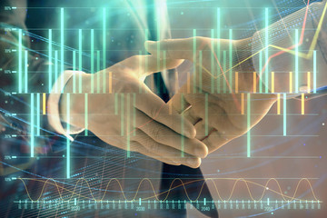 Multi exposure of forex graph on abstract background with two businessmen handshake. Concept of success on stock market