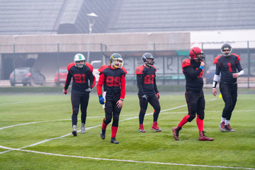 Wall Mural - confident American football players leaving the field