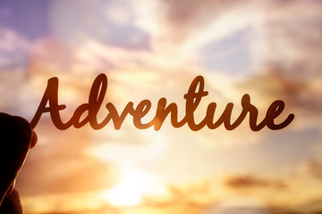 Adventure word summer vacation concept written against sunset
