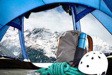 Wall Mural - Winter backpack in blue tent and mountains landscape 