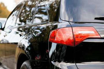 Wall Mural - Back view of new white car. Closeup headlights of car. White premium city crossover, luxury SUV rear light closeup. Car lamp close-up.