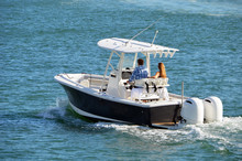 Man And A Woman Enjoying A Slow Cruise On The Florida Intra-Coastal Waterway Off  Miami Beach In A Sport Fishing Boat