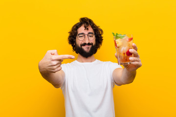 young crazy bearded man with a cocktail. tourist concept