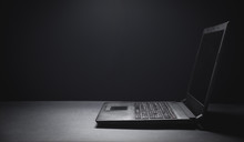 Black Laptop On The Black Office Desk. Technology Concept