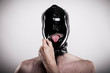 © vizualni - submissive man open the zipper of his black shiny rubber mask. his head is fully covered with the glossy material