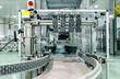 © Ratchapon - Close up Belt conveyor glass bottles into beverage filling machine