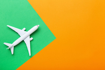 Airplane model on colorful paper background