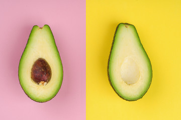 Wall Mural - two halves of avocado on a colored background