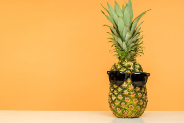 Wall Mural - bright juicy pineapple in sunglasses