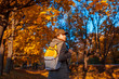 © maryviolet - Tourist with backpack walking in autumn forest. Young woman travel at sunset