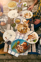 Group of diverse friends serving a balanced dinner al fresco in urban setting