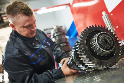 Fotomural Truck repair service. serviceman works gear shaft of gearbox
