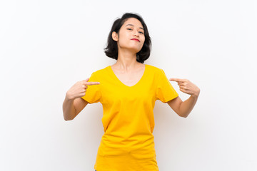 Asian young woman over isolated white background proud and self-satisfied