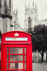 Poster - Old british red phone booth with the York Cathedral on the background - Background in black and white