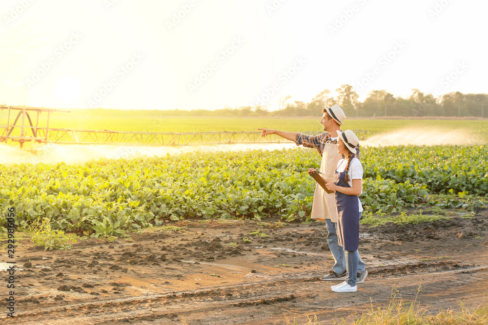Young farmers working in field