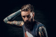 © Fxquadro - Portrait of hopeless bearded man with hairstyle on the black background.