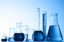 Different Laboratory Glassware With Color Liquid And With Reflection