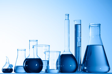 Wall Mural - different laboratory glassware with color liquid and with reflection