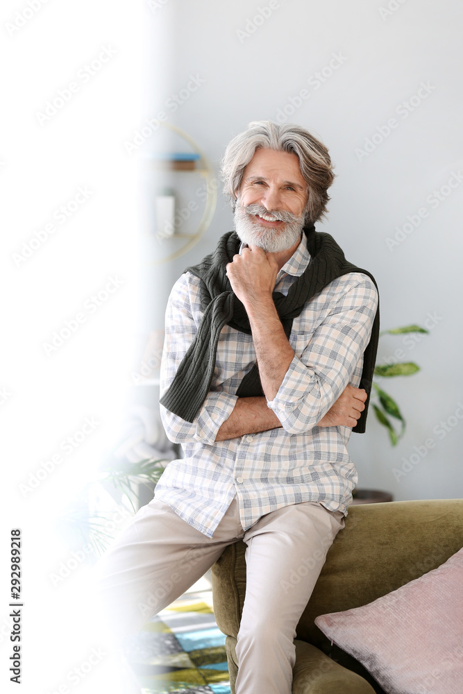 Portrait of handsome senior man at home