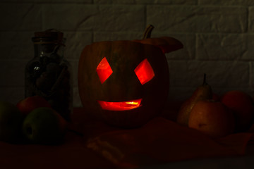 carved pumpkin for halloween lies on a table at home