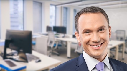 Portrait of happy businessman on background