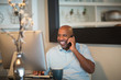 © digitalskillet1 - Mature African American man working from his home office.