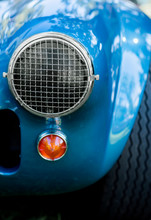 Mesh Headlight Cover On The Front Grille Of Blue Retro Car, Vintage Car Show