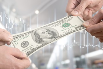 Wall Mural - Hands holding one hundred dollars banknote over background