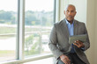 © digitalskillet1 - Mature African American man working on a tablet.