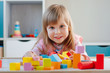 © lithiumphoto - Smiling little girl playing with color wooden blocks