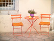 Orange chairs and table on the street