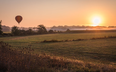 Sticker - Hot air balloon lifts off over a farm field at sunrise, Pine Island, NY, early fall