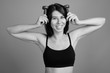 © Ranta Images - Young beautiful woman ready for gym against gray background