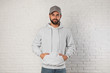 © New Africa - Portrait of young man in sweater at brick wall. Mock up for design