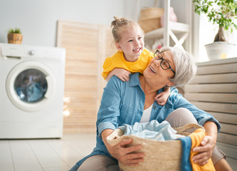 Wall Mural - grandma and child are doing laundry