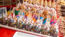 Assorted Variety Of Colorful Candy Apples For Sale In A Sweet Store