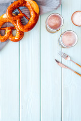 Wall Mural - Octoberfest table background. Pretzels and beer glasses on blue wooden background top view frame space for text