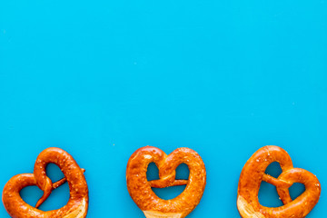 Pretzels frame, blue background top view copy space