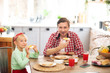 © zinkevych - Father and daughter enjoying weekend breakfast at home