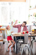 © zinkevych - Daughter giving high five to father while having yummy breakfast