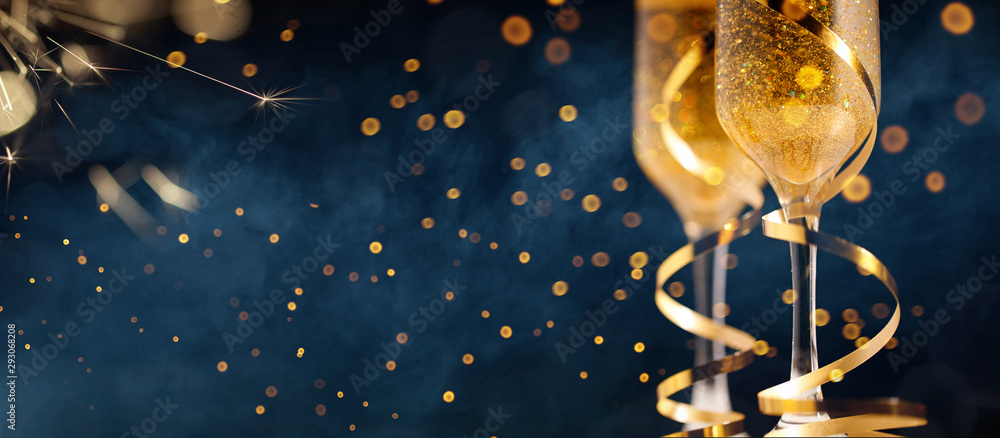 Two glasses of champagne with golden confetti, glitter, serpentine and lights. - obrazy, fototapety, plakaty 