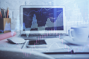 Stock market graph and table with computer background. Multi exposure. Concept of financial analysis.