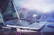 © peshkova - Stock market graph and table with computer background. Multi exposure. Concept of financial analysis.