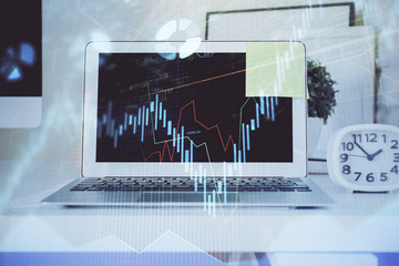 Forex Chart hologram on table with computer background. Double exposure. Concept of financial markets.