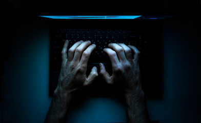 Top view of the hands of a programmer on  his laptop