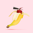 Unusual combination of usual things. Fire extinguisher as a banana on trendy coral background. Negative space. Modern design. Copyspace. Contemporary art. Creative conceptual and colorful collage.