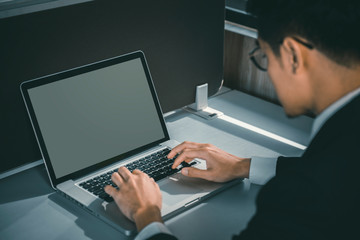 professional businessman in suit working on new business project with notebook computer while sitting at his office.