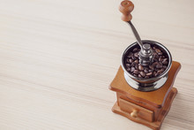 Vintage Manual Coffee Grinder With Roasted Coffee Beans