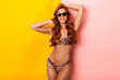 © Drobot Dean - Photo of glamorous woman wearing leopard bikini and sunglasses looking at camera while smiling