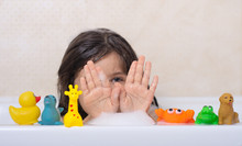 Hygiene For Infant And Baby. Child Playing With Soap Foam In Home Bathroom. Rubber Duck In Foam Bath.